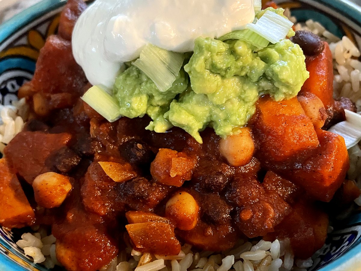Three bean and sweet potato chilli with guacamole and tortilla chips